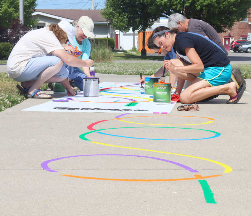 Volunteer group paints to promote physical activity for children